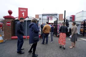 Fans gather outside Old Trafford cricket ground after the final Test match between England and India was canceled