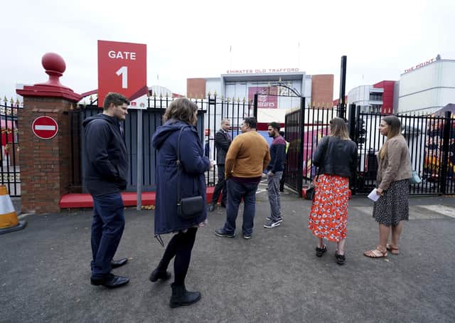 Fans gather outside Old Trafford cricket ground after the final Test match between England and India was canceled