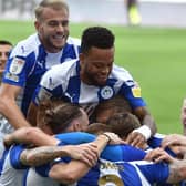 The Latics side celebrate the second goal from Will Keane