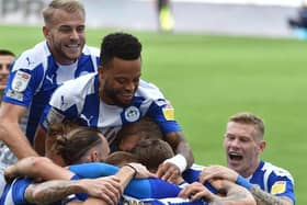 The Latics side celebrate the second goal from Will Keane