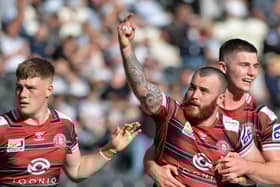 Jake Bibby is congratulated on his try