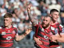 Jake Bibby is congratulated on his try