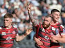 Jake Bibby is congratulated on his try