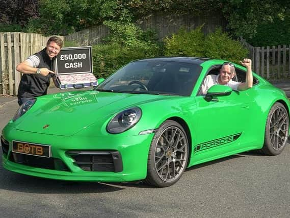 Kenneth Hindle behind the wheel of the Porsche 911 Turbo he won thanks to online competitions company BOTB. Kenneth, from east Lancashire, was presented with the car and £50,000 in cash by BOTB's Christian Williams (right)