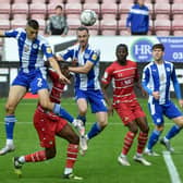Kell Watts heads for goal against Doncaster