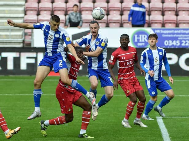 Kell Watts heads for goal against Doncaster