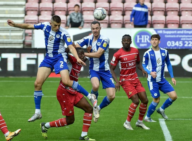 Kell Watts heads for goal against Doncaster