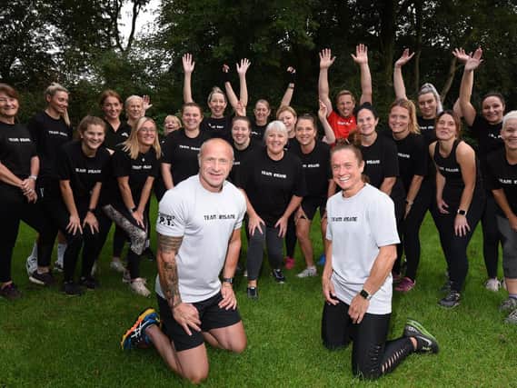 Personal trainers Andrew Hosker, front left, and Carol Gorner, front right, with members of Train Insane, who are doing a trek up Snowdon to raise funds for a defibrilator for the group and other sports group who use the grounds of R.L.Hughes Primary School fields.