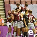 Wigan players celebrate Willie Isa's first-half try