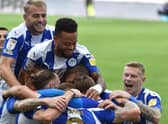 The Latics players celebrate the winning goal against Doncaster