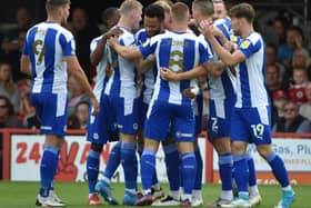 The Latics players celebrate another great win - which sent them top of League One
