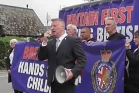 Paul Golding (holding the megaphone) leads the protest