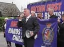 Paul Golding (holding the megaphone) leads the protest
