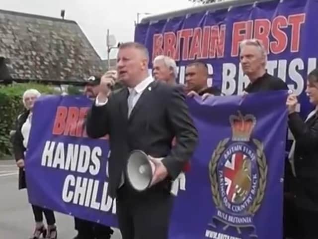 Paul Golding (holding the megaphone) leads the protest