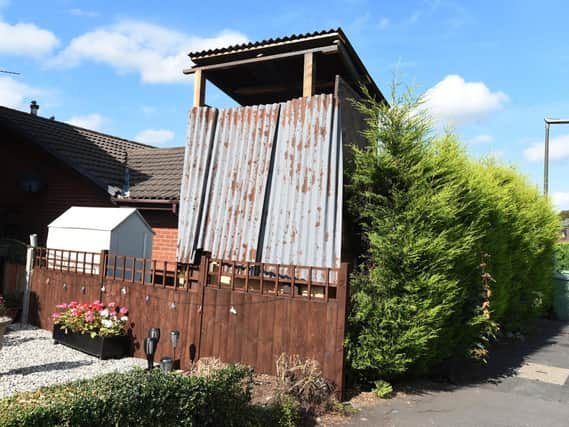 The construction of a makeshift play area in the front garden of a home has upset neighbours