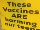 One of the signs - bearing a fake claim about the Covid jab - held aloft outside Lytham St Annes High School earlier this week