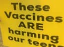 One of the signs - bearing a fake claim about the Covid jab - held aloft outside Lytham St Annes High School earlier this week