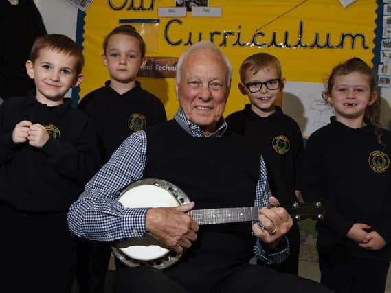 Dennis Lee, vice president of the George Formby Society, visits Year Two pupils at Hindley Junior and Infant school, as the class history topic is George Formby