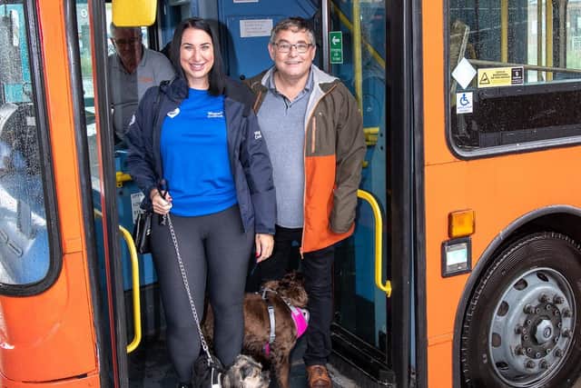 Councillor Chris Ready and Wigan Council staff Lindsey Carrington on board the Haigh Woodland Wanderer bus with their dogs.