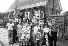 Waving goodbye during the last week at Red Rock Primary School before closure are young pupils, Head, Fred Fearnley, Vicar of St. David's, Haigh, Rev. Ted Rowlands, teachers and longest surviving schoolgirl, Jessie Abbot, aged 90, who attended the school from 1895 to 1903 and later worked at the Bleachworks at Worthington.
The school was closing after 106 years in July 1981.