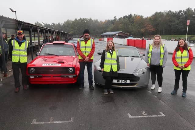 Galloway's staff next to Ford Escort MK2 and Aston Martin Vantage V8