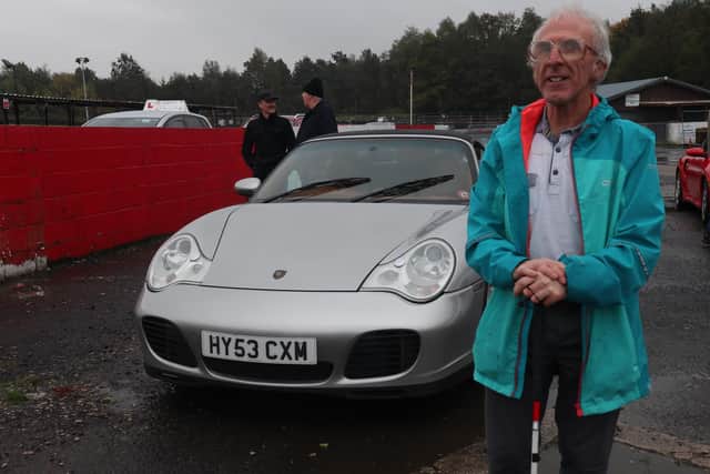 David Evans next to a Porsche