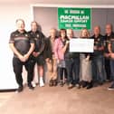 Joe Fitzsimmons presents a cheque to Mcamillan Cancer Support