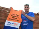 Martyn with the jersey he will be completing his challenge in