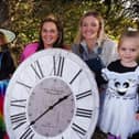 From left: Connie Boyd, three, Erin Boyd, farm manager Shannon Caffrey and Arabella Speakman, two, give us the clocks-back reminder at Apple Cast Farm