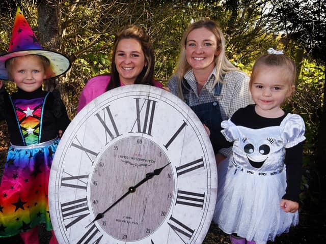 From left: Connie Boyd, three, Erin Boyd, farm manager Shannon Caffrey and Arabella Speakman, two, give us the clocks-back reminder at Apple Cast Farm