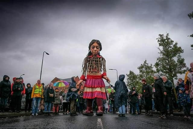 Little Amal walks through Wigan