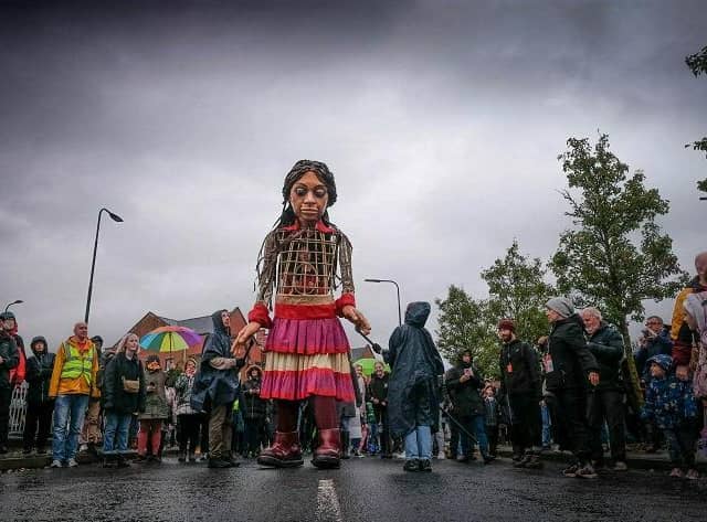 Little Amal walks through Wigan