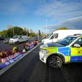 Protesters from Insulate Britain blocking a road near the Holiday Inn Express near Manchester Airport this morning (Tuesday November 2). Pic: PA Wire/PA Images