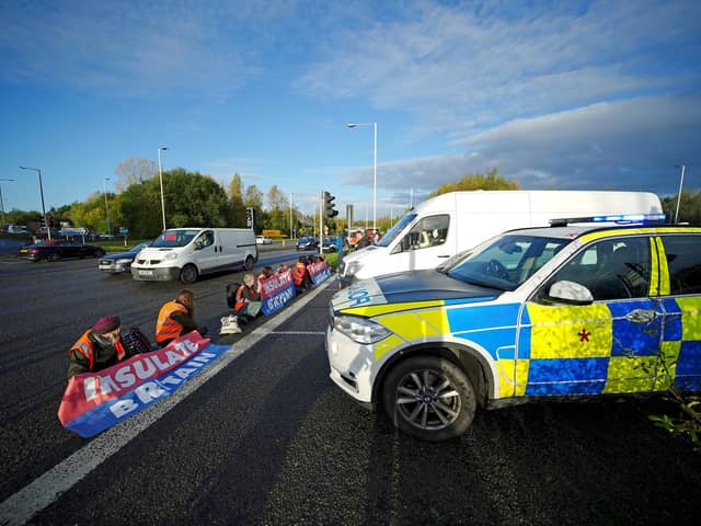 Protesters from Insulate Britain blocking a road near the Holiday Inn Express near Manchester Airport this morning (Tuesday November 2). Pic: PA Wire/PA Images