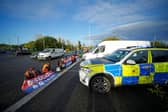 Protesters from Insulate Britain blocking a road near the Holiday Inn Express near Manchester Airport this morning (Tuesday November 2). Pic: PA Wire/PA Images