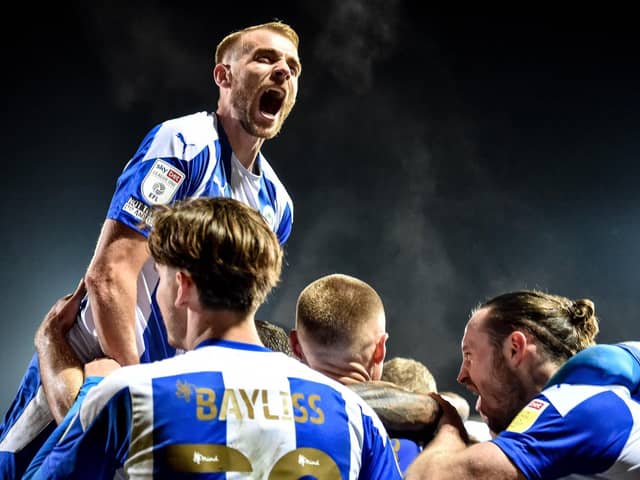 Jack Whatmough leads the celebrations at Fleetwood