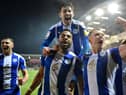 The Latics players celebrate their late heroics at Fleetwood in midweek
