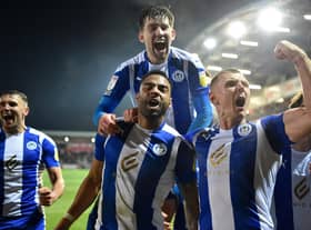 The Latics players celebrate their late heroics at Fleetwood in midweek