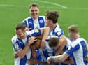 Curtis Tilt is mobbed after scoring against Burton last weekend