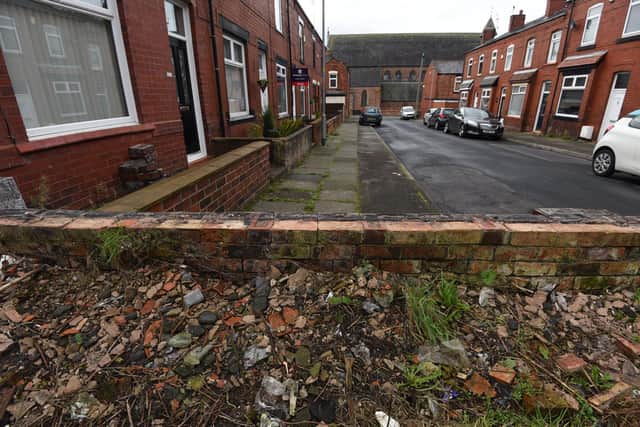 General view of Whiteside Avenue, Springfield, Wigan - the wall has been removed leaving residents exposed.
