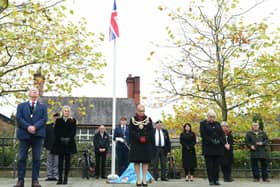 Wigan Council leaders observe the two minutes' silence in Believe Square