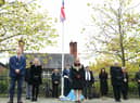 Wigan Council leaders observe the two minutes' silence in Believe Square