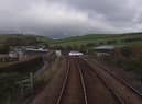 A still image from a Network Rail video showing a driver taking their life in their hands by jumping red lights at a level crossing in Cumbria.