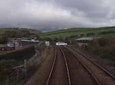 A still image from a Network Rail video showing a driver taking their life in their hands by jumping red lights at a level crossing in Cumbria.