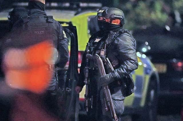 Armed officers swooped to arrest three men under the Terrorism Act