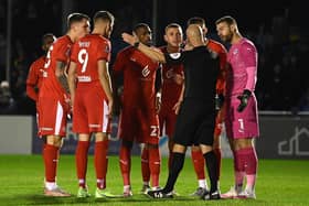 The Latics players protest about the award of Solihull's penalty