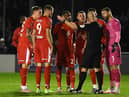 The Latics players protest about the award of Solihull's penalty