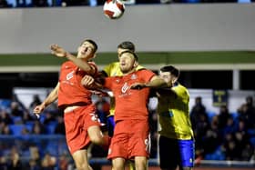 Kell Watts and Charlie Wyke compete for the ball at Solihull