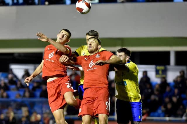 Kell Watts and Charlie Wyke compete for the ball at Solihull