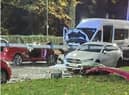 The red BMW with its roof removed and the crumpled front end of the minibus